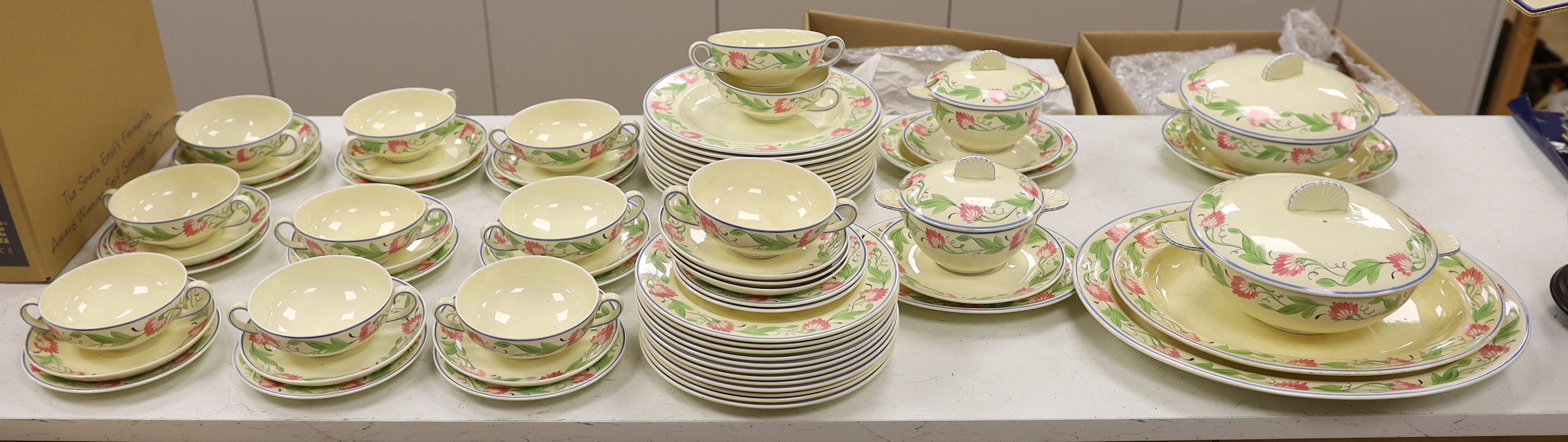 A Wedgwood floral pattern dinner service, c.1934 including twin handled cups, dinner plates and serving dishes, largest 42cm wide